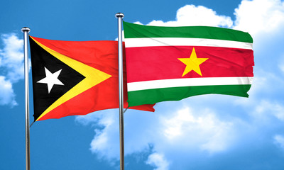 east timor flag with Suriname flag, 3D rendering