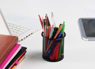 Stack of books and stationery isolated on white background