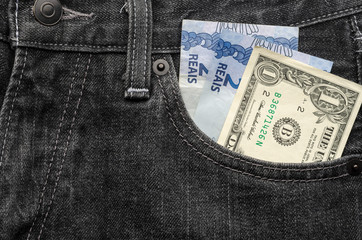 One dollar and four brazilian real money inside jeans pocket