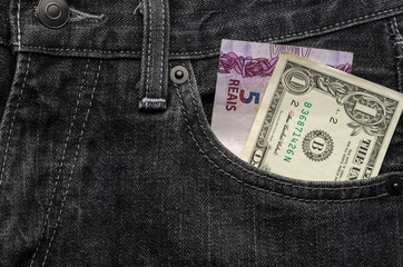 One dollar and five brazilian real money inside jeans pocket