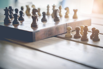 Chess board on wooden table with vintage filter effect