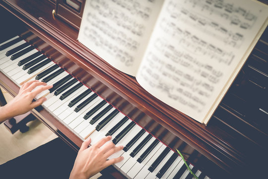 Musician playing piano with vintage filter