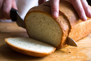 Person slicing freshly homemade bread