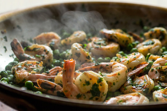 Green garlic shrimp cooking in pan