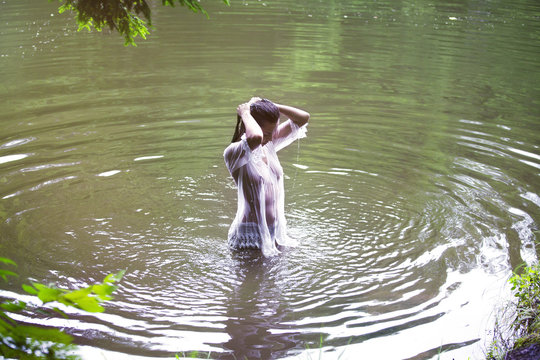 Young woman swimming in river