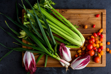Fresh vegetables on wooden chopping board