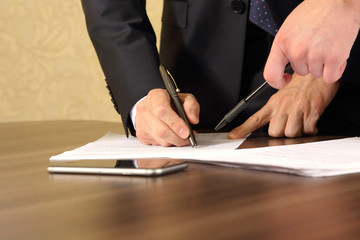 hands of business men and women studying the documents