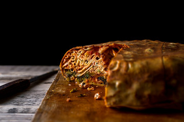 Timpano on chopping board with missing piece