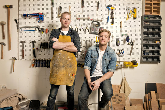 Portrait of mid adult men  in carpentry workshop