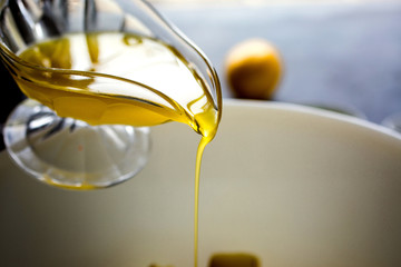 Pouring lemon salad dressing from jug