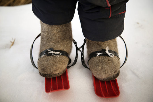 Child (4-5) wearing plastic skis