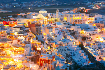 Fira, modern capital of the Greek Aegean island, Santorini, with Orthodox Metropolitan Cathedral at night, Greece