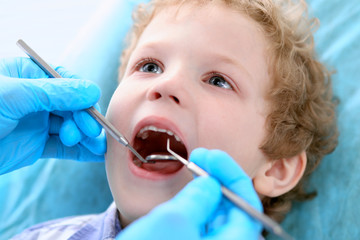 Close up of boy having his teeth examined by a dentist