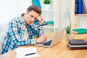 Tired young man having problems with writing new book