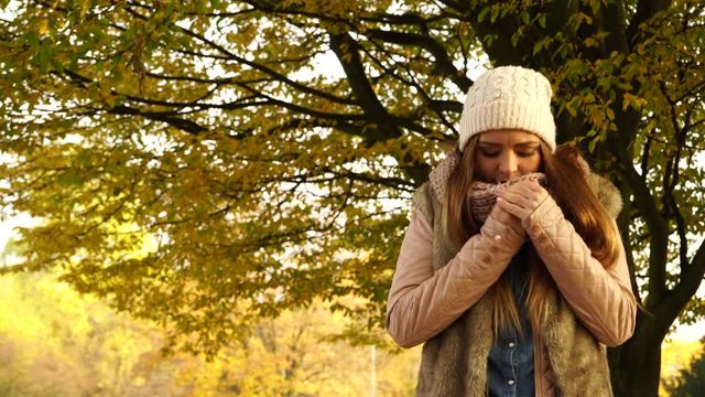 Woman with pills tablets in autumn fall park 4K.