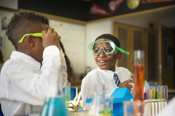 Students wearing safety goggles in science classroom