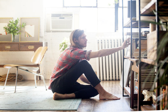 Young man looking for book