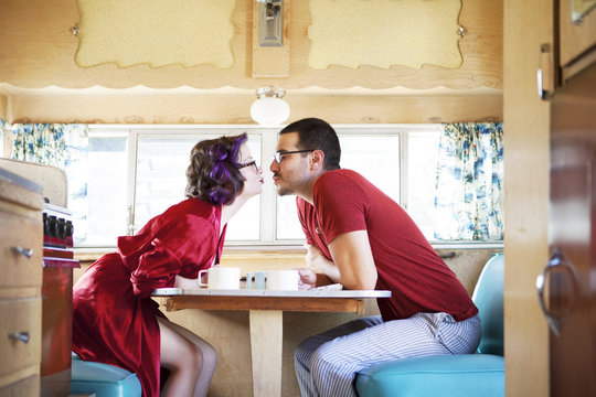 Couple having breakfast in camper van