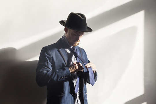 Portrait of man tying tie