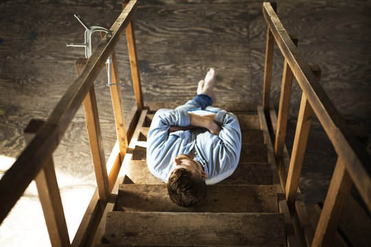 Young Man Lying On Stairs