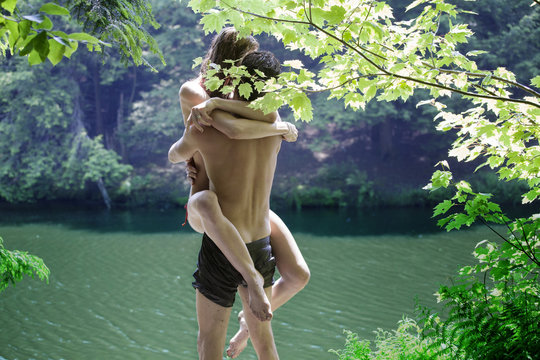 Passionate couple kissing in forest