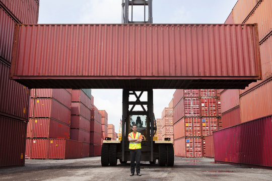 Worker standing in front of freight container