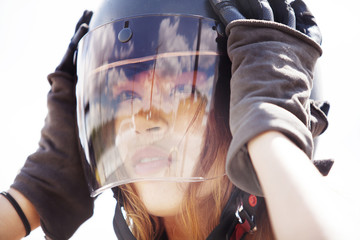 Young woman wearing motorcycle helmet