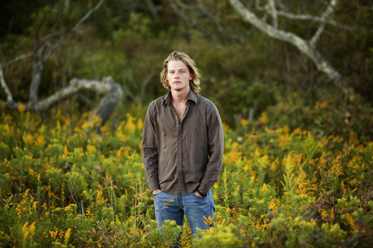 Portrait Of Young Man Standing In Nature