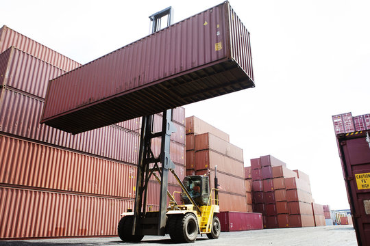 Forklift moving large cargo container