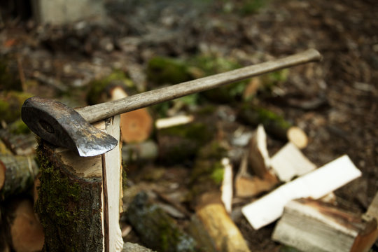Close-up of axe on firewood