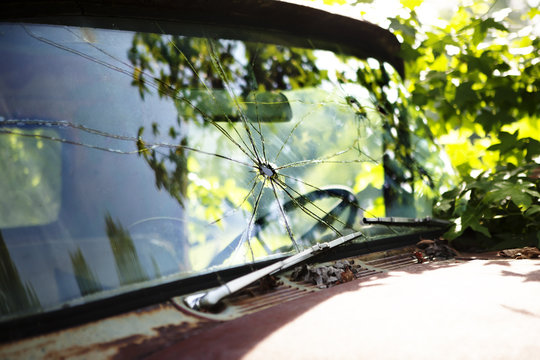 Close-up view of broken window in old truck