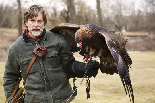 Portrait of man with falcon on hand