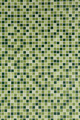 Toilet Wall of made of different hues in green tiles.