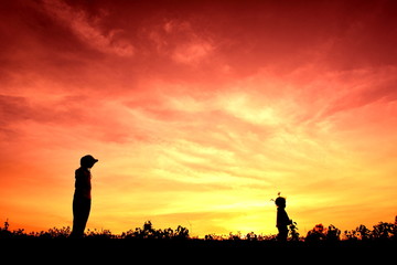 Fototapeta premium Silhouette little girl at sunset