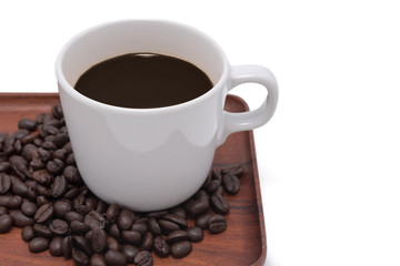 Coffee cup and beans on wooden tray isolate on white background