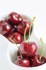 Cherry in the white cup.