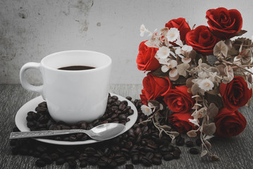 Coffee cup and beans on wooden