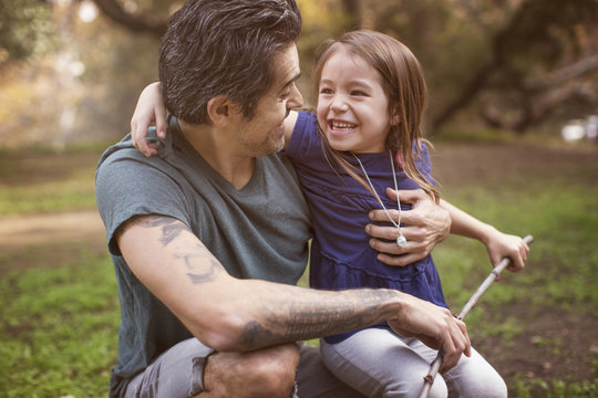 Father and daughter (4-5) outdoors