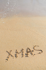 Fototapeta na wymiar Xmas word sign on tropical beach background