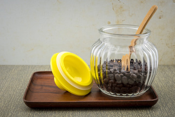 Glass jar of coffee on wooden