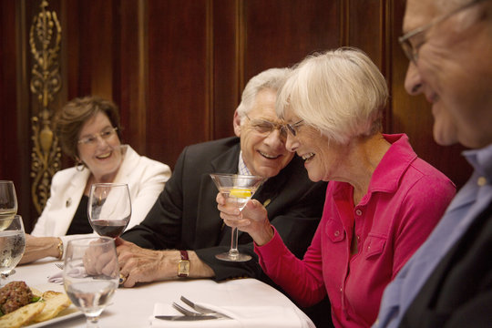 Senior friends having drink in restaurant