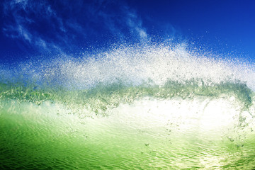 Close-up of wave splashing in sea against blue sky