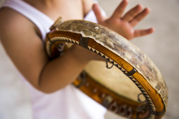 Сhild with uzbek national instrument doira