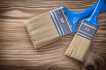 Paint brushes on wooden board construction concept