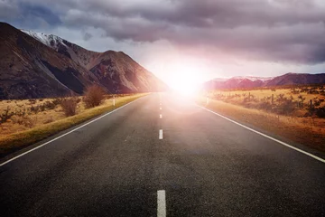 Poster beautiful sun rising sky with asphalt highways road against snow © stockphoto mania