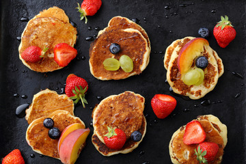 pancakes with berries on dark background