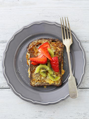 french toast with fruits on gray plate