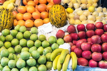 Apples, pears and melons for sale at a market