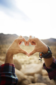Cropped image of hands making heart shape