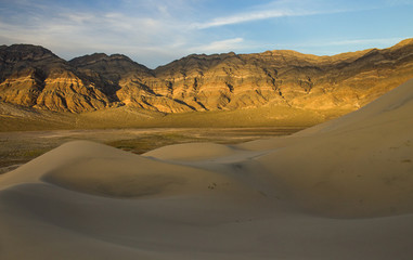 Fototapeta na wymiar Late afternoon light and colour on the rocks on the last chance mountains rising above Eureka Dunes, Death Valley National Park, California, United States